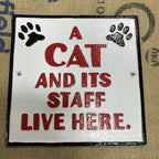 A Cat And Itâs Staff Live Here Cast Iron Sign