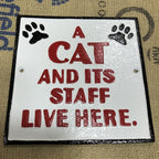 A Cat And Itâs Staff Live Here Cast Iron Sign