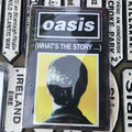 Oasis Whatâs The Story Tin Sign