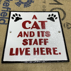 A Cat And Itâs Staff Live Here Cast Iron Sign