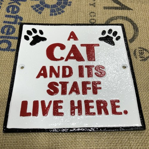 A Cat And Itâs Staff Live Here Cast Iron Sign